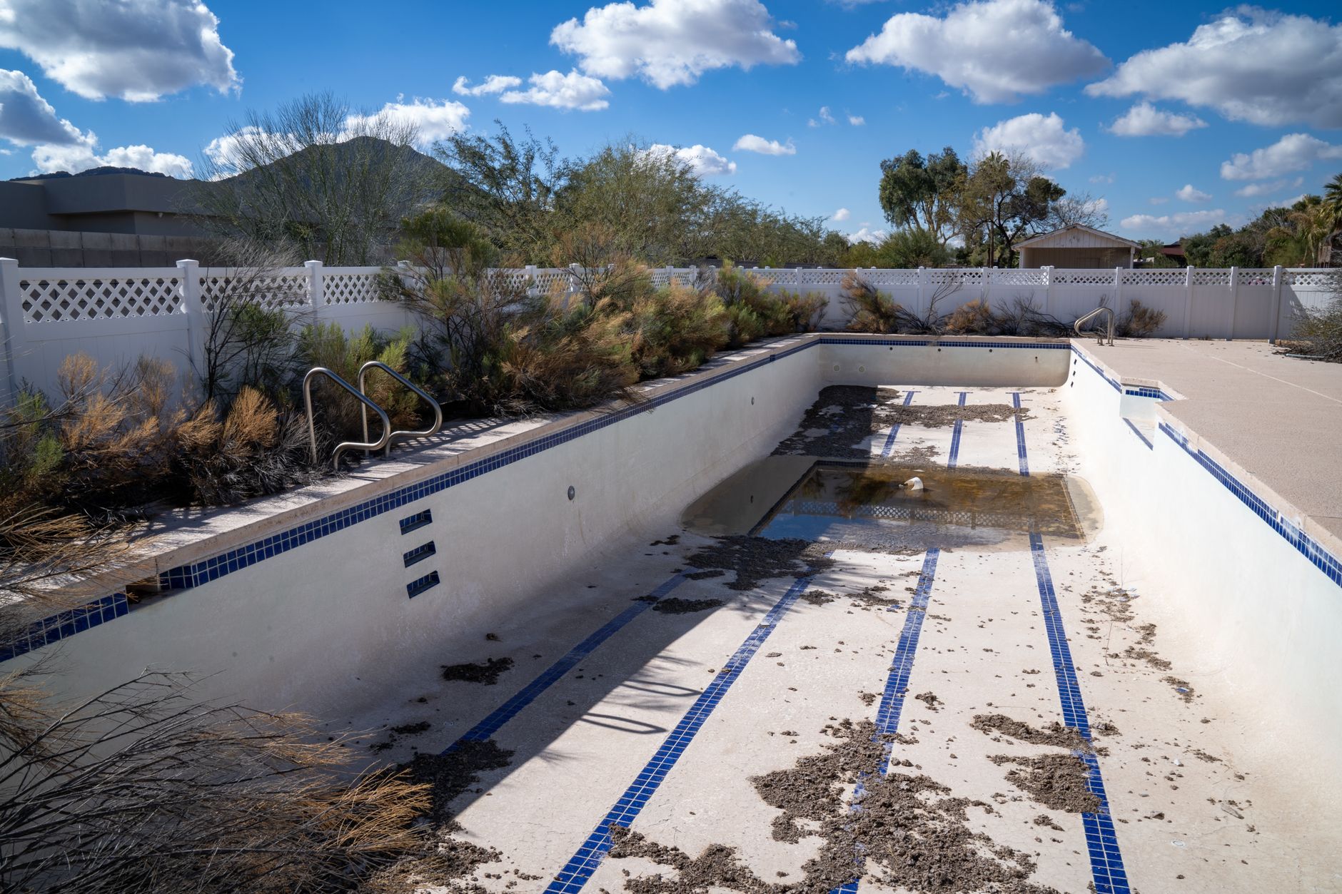 A before-and-after split image of an Arizona pool resurfacing project. The left side shows an old, cracked white plaster