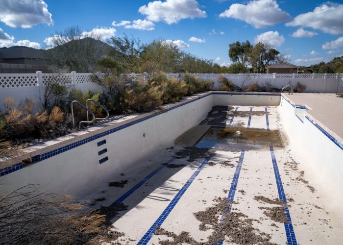 A before-and-after split image of an Arizona pool resurfacing project. The left side shows an old, cracked white plaster